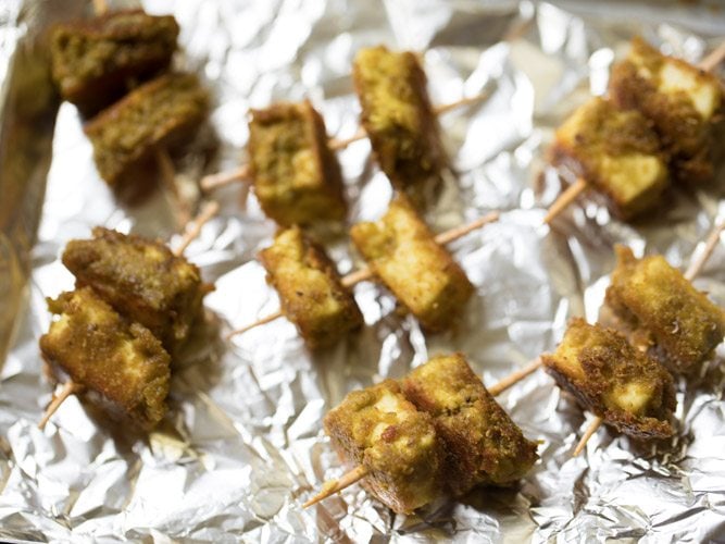 pan fried hariyali paneer tikka skewered onto toothpicks. 