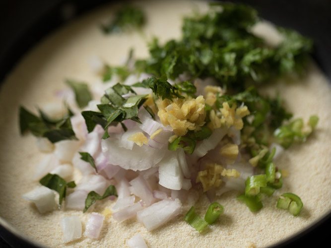 chopped onions, finely chopped ginger, chopped green chilies, chopped coriander leaves and chopped curry leaves added to rava. 