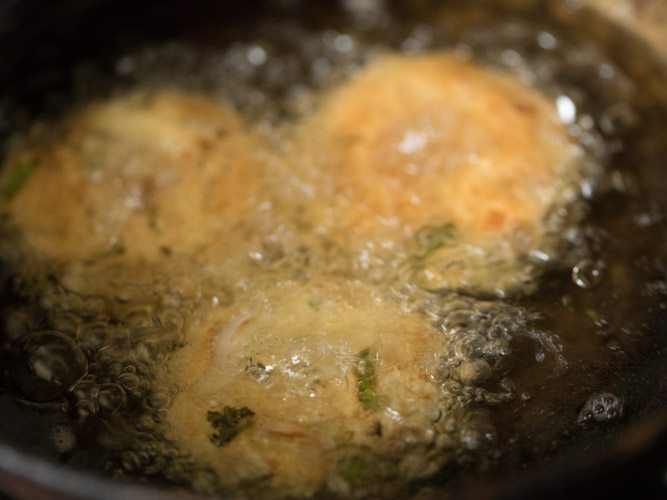 one side golden vadas turned over and fried in hot oil. 