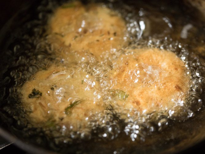 frying vadas till crisp and golden. 