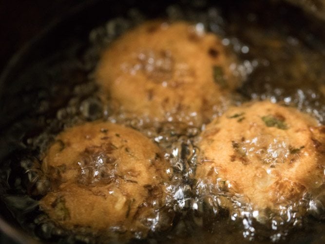 frying vadas till crisp and golden. 