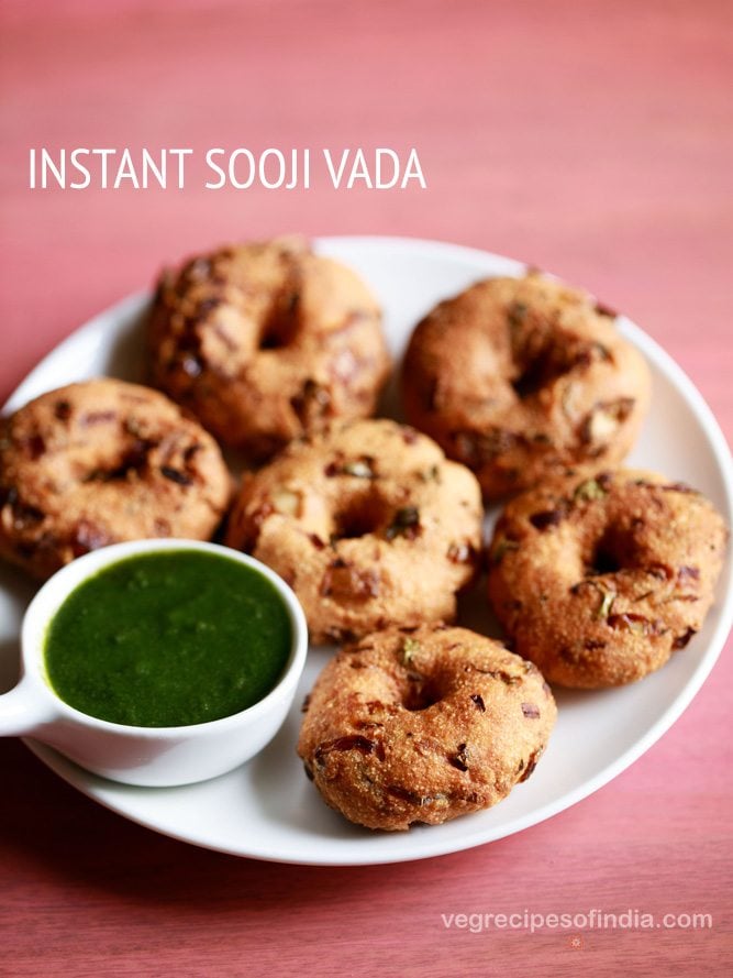 rava vada served on a white plate with a small bowl of green chutney kept on the left side and text layovers. 