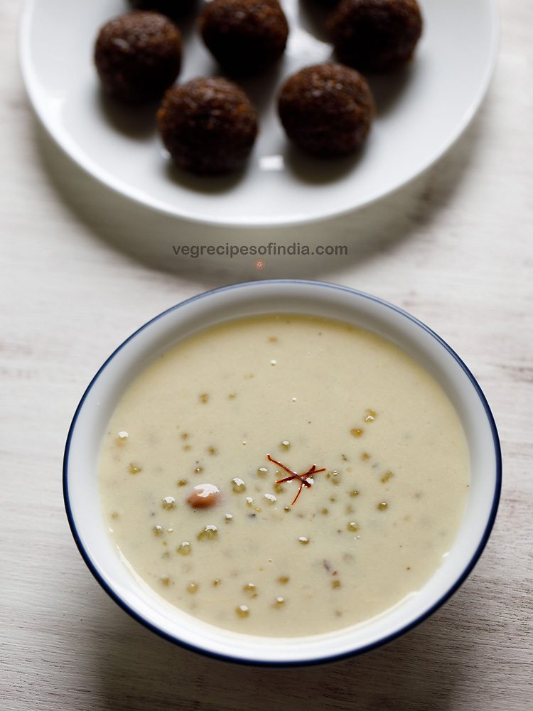 javvarisi payasam served in a white colored blue rimmed bowl with 3 saffron strands in the center