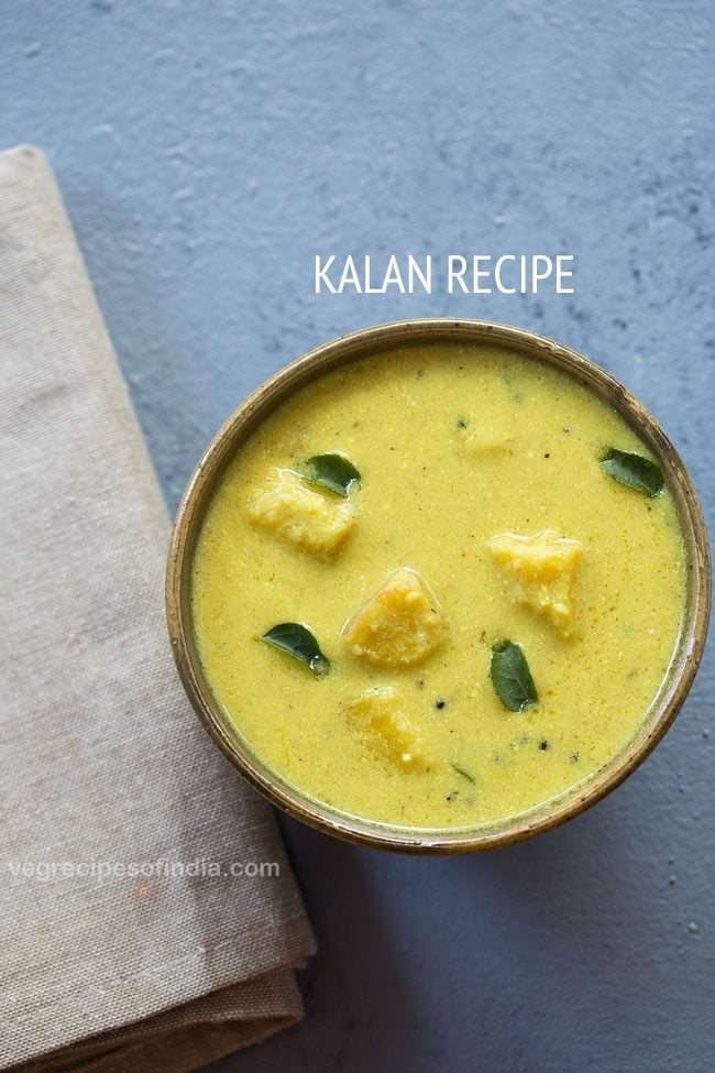 kalan garnished with curry leaves and served in a brown ceramic bowl with text layovers.