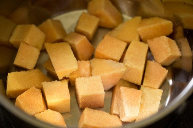 chopped suran added in a pan for kalan recipe. 