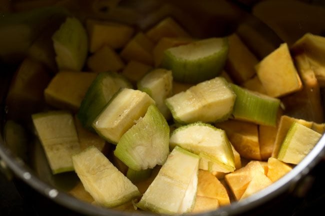 chopped plantain added to the pan for kalan recipe.