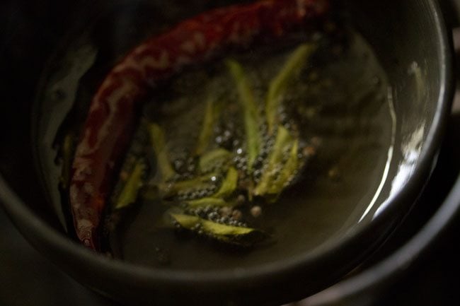 dried red chilies and curry leaves added to the hot oil. 