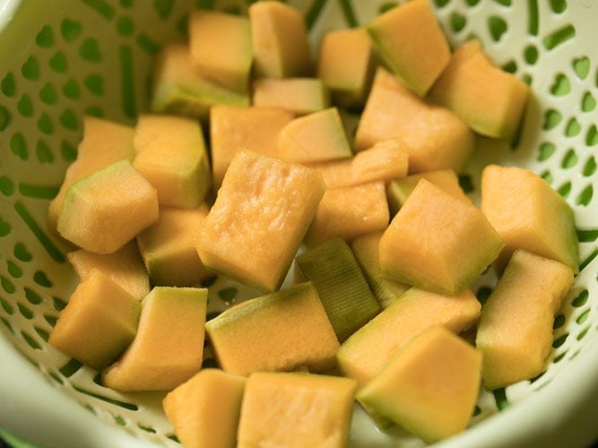 chopped pumpkin cubes in a colander.