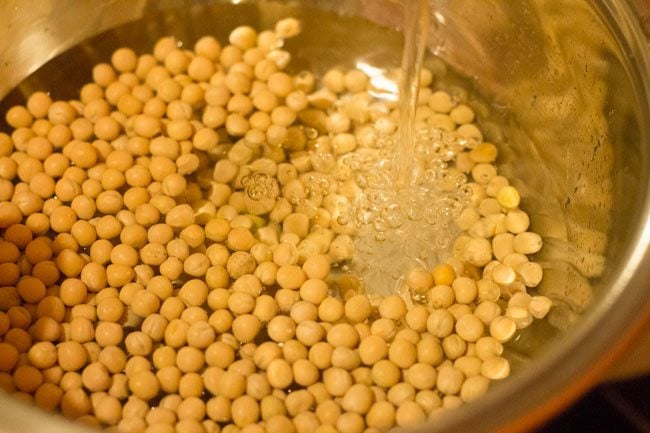 rinsing dried white peas in water. 