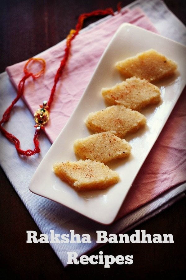 coconut burfi on a white platter with red rakhi at the side.