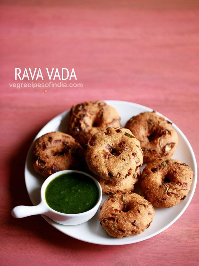 rava vada served on a white plate with a small bowl of green chutney kept on the left side and text layovers.