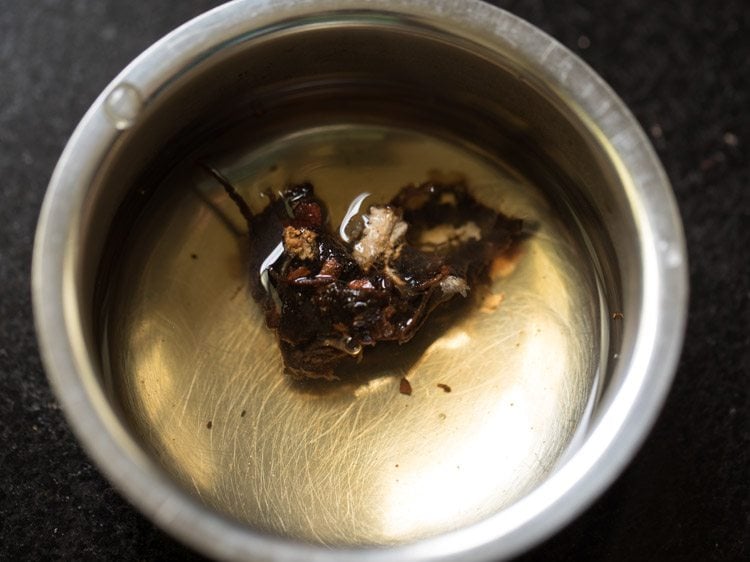 soaking tamarind in hot water for rishi panchami bhaji. 