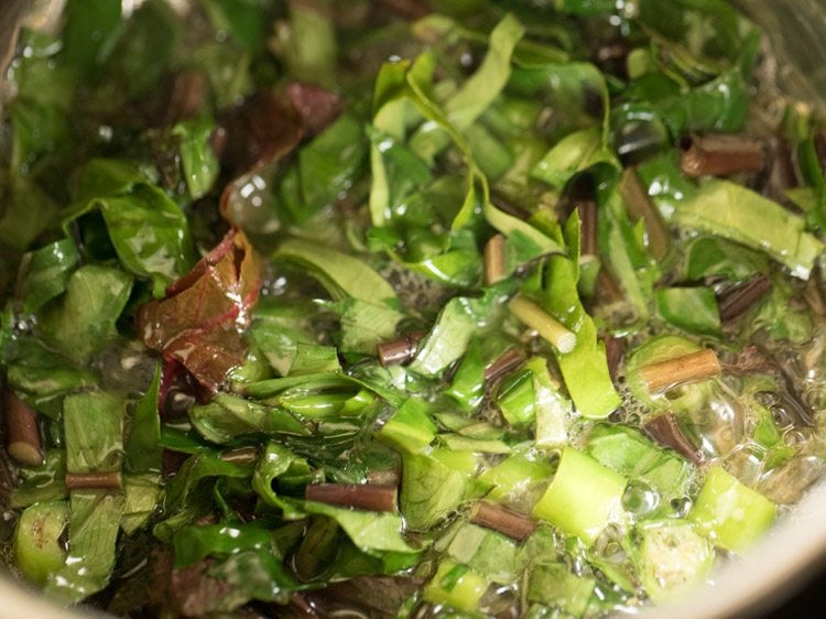 sautéing leafy greens for rishi panchami bhaji. . 