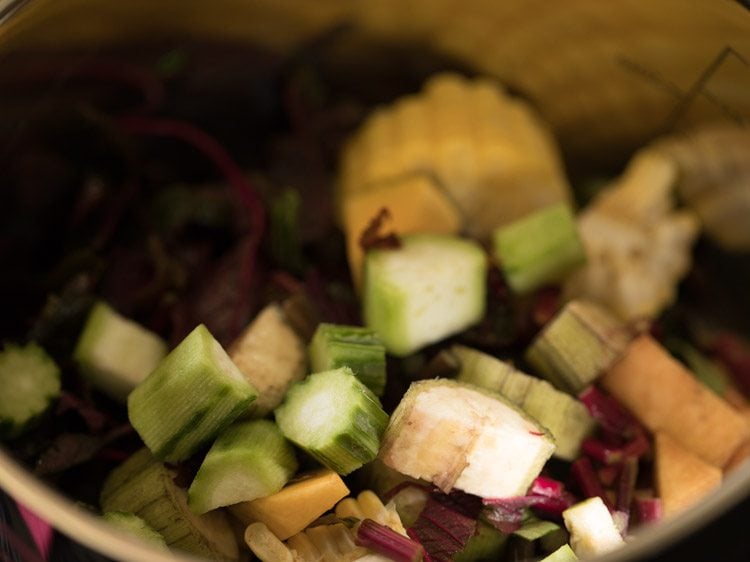 chopped vegetables added to pan for rishi panchami bhaji. .
