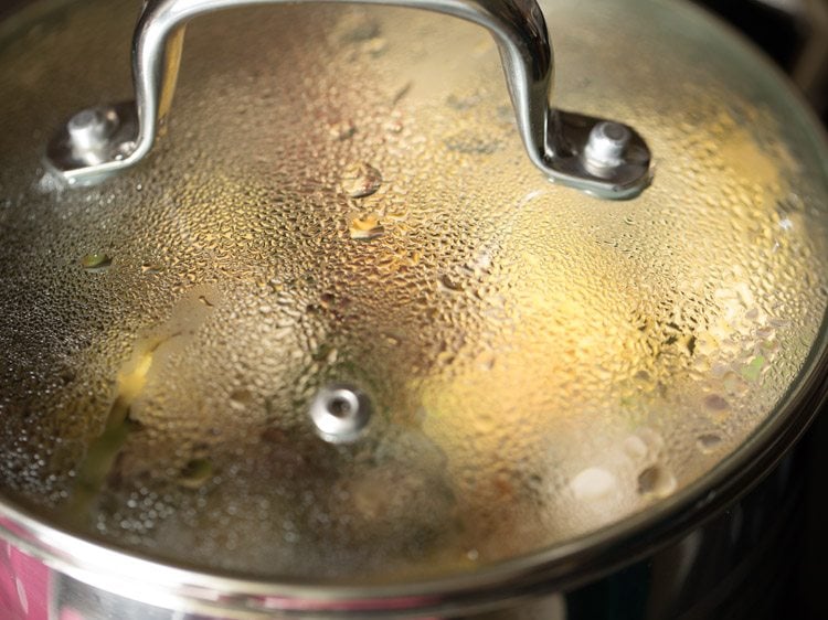 cooking rushichi bhaji in the covered pan. 