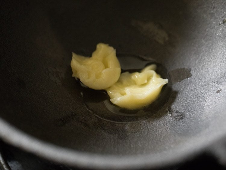 ghee added in a cast iron pan.