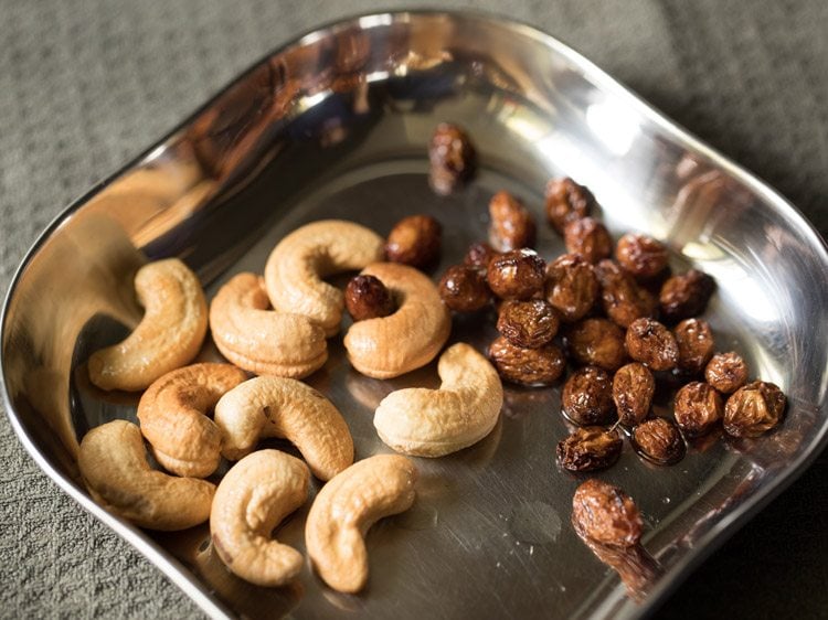 cashews and raisins set aside in a steel plate to make javvarisi payasam. 