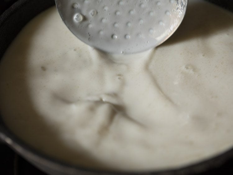 mixing sugar with a slotted spoon. 