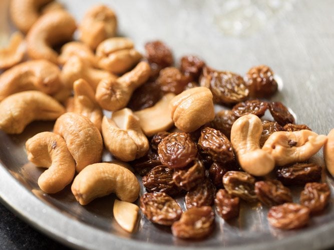 fried golden cashews and raisins set aside in a steel plate for semiya payasam