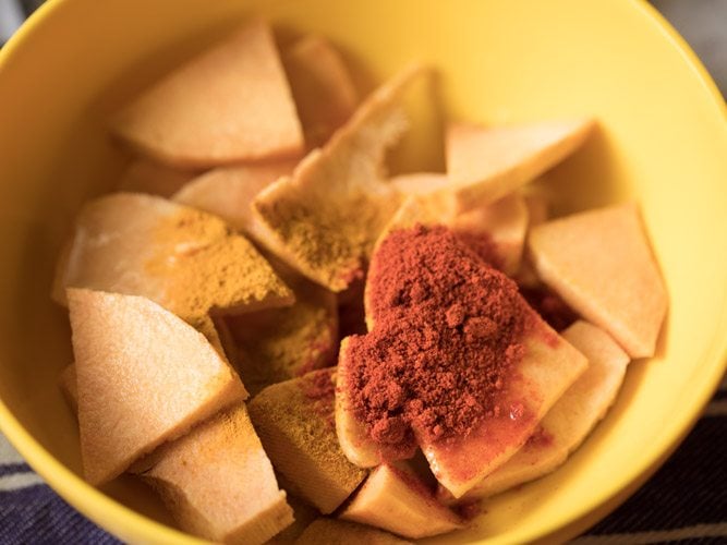 ground spices on top of the yam slices