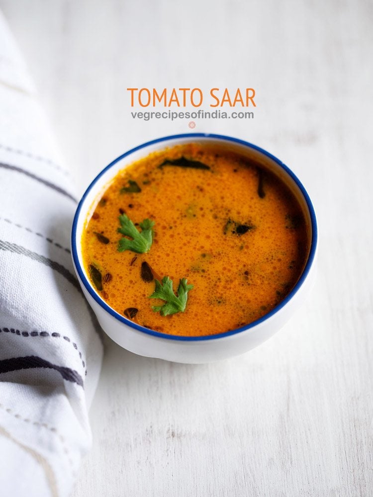 tomato saar served in a blue rimmed white ceramic bowl with text layovers.