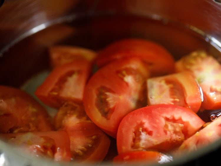 quartered tomatoes added to the boiling water. 