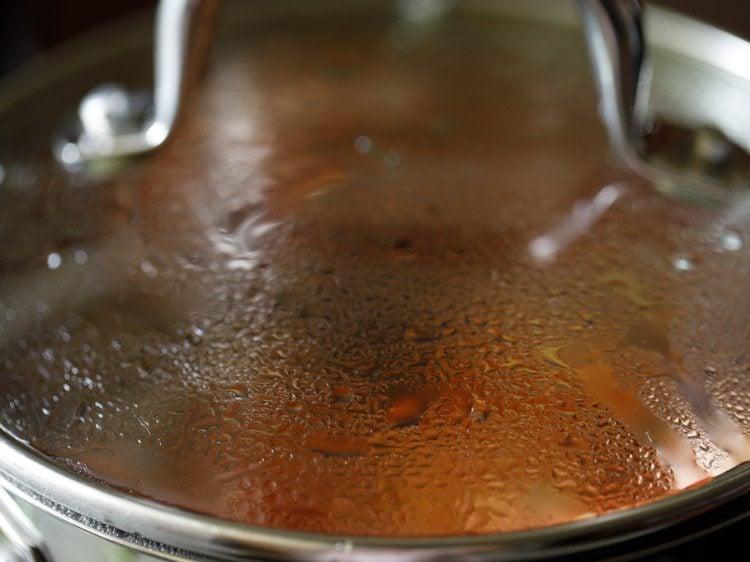 simmering tomatoes till they turn tender. 