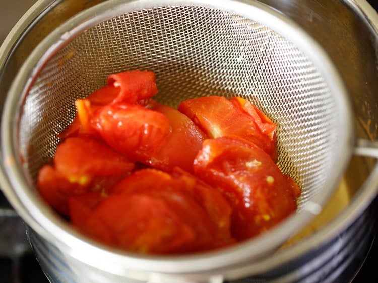 straining cooked tomatoes. 