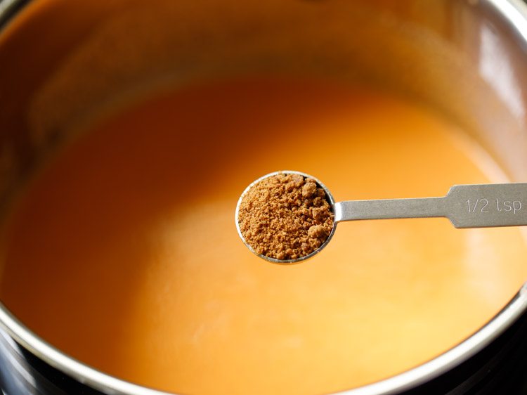 adding jaggery to the pan. 