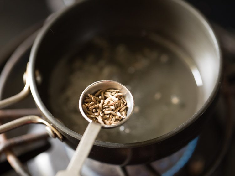 adding cumin seeds to the hot oil. 