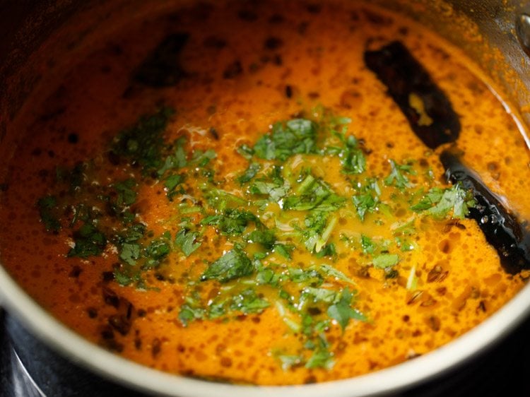 chopped coriander leaves added to the tomato saar. 
