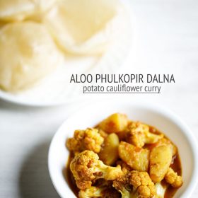 aloo phulkopir dalna served in a white bowl with a plate of luchi kept on the top left side and text layovers.