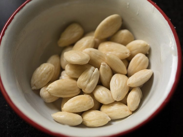 peeled almonds in a bowl for badam kheer recipe.