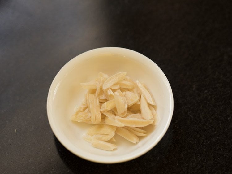 thinly sliced blanched almonds for badam kheer recipe.