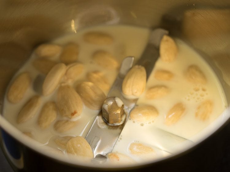 peeled blanched almonds and milk added in a grinder jar.