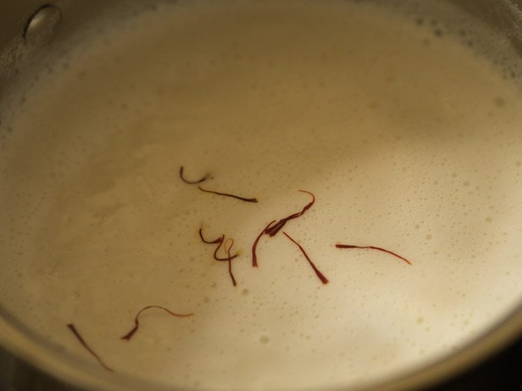 saffron strands added to boiling milk.
