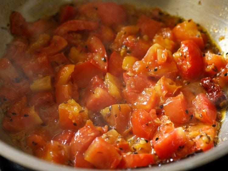 cooking tomato mixture till soft and mushy.