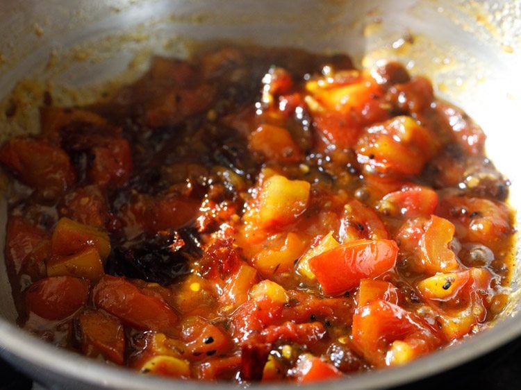 cooking tomato khejur chutney. 