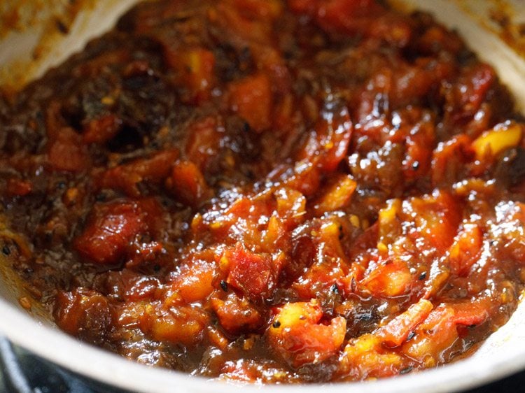 cooking tomato khejur chutney till it thickens. 