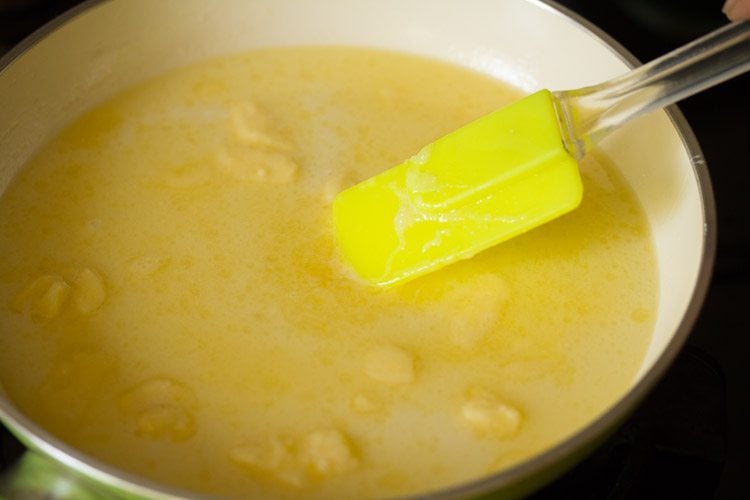 yellow spatula stirring sponge batter wet ingredients