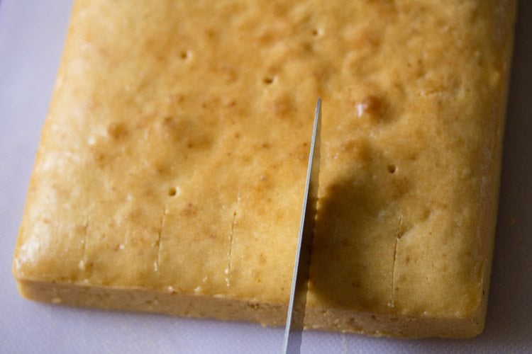 slicing sponge cake into fingers for making tiramisu recipe