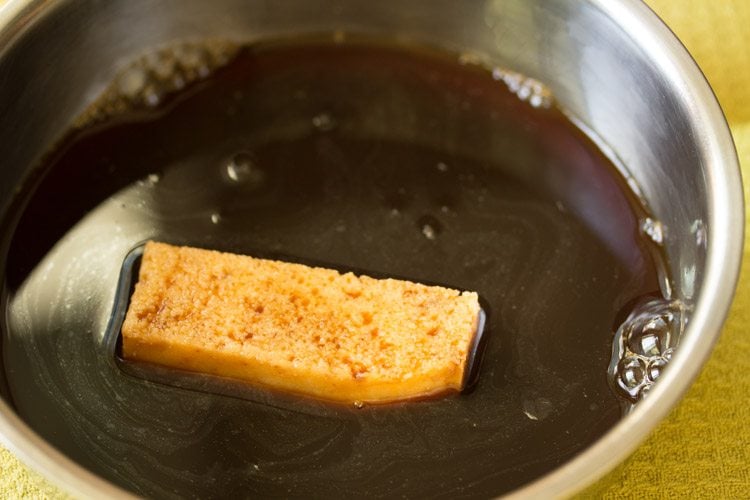 soaking lady finger in espresso syrup for tiramisu