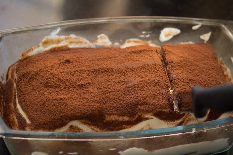 knife cutting a slice of tiramisu