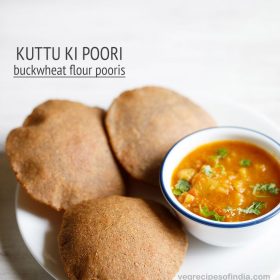 kuttu ki puri served on a white plate with a bowl of vratwale aloo sabzi in a blue rimmed bowl kept on the right side and text layovers.