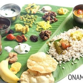 onam sadhya served on a banana leaf with text layover.