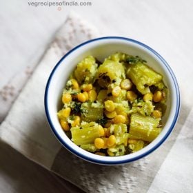 snake gourd recipe served in a blue rimmed white bowl with text layovers.