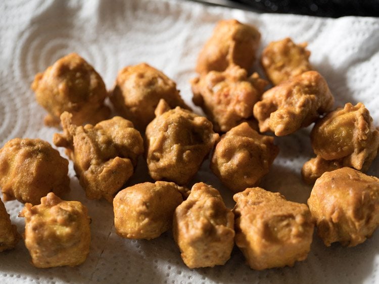 paneer koliwada or fried paneer placed on kitchen paper towel. 