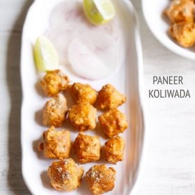 paneer koliwada or fried paneer cubes on a white platter with onion slices and lemon wedges.