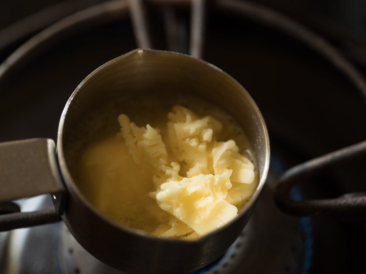 heating butter in a small pan for making the dough for ribbon murukku. 