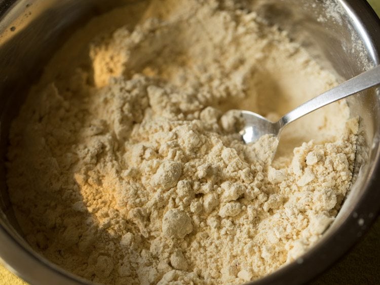 mixing melted butter with a spoon into the sifted mixture. 